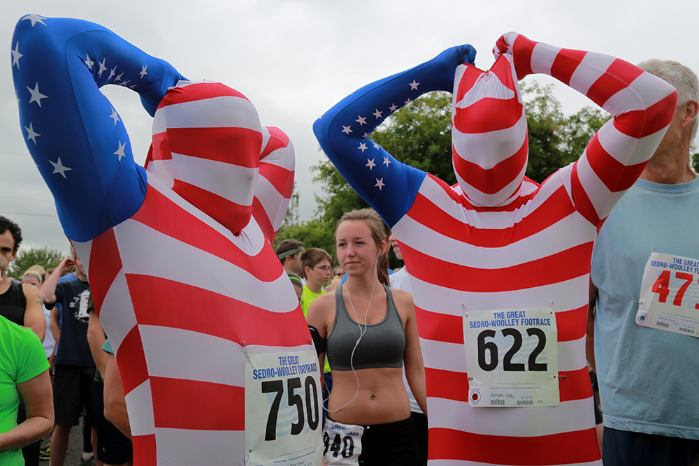 Ryan Welch (left) and Joe Jones pull the hoods of their patriotic morphsuits over their heads before starting the Great Sedro-Woolley Footrace on July 4, 2013. "It's almost being naked, but not," Jones said.  Brooke Warren / Skagit Valley Herald